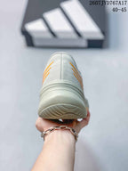 Rear view of the light gray sneaker showing the layered heel design and textured outsole.