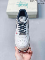 Top view of the sneaker showing the perforated toe box, dark laces, tongue branding, and decorative lace hardware.