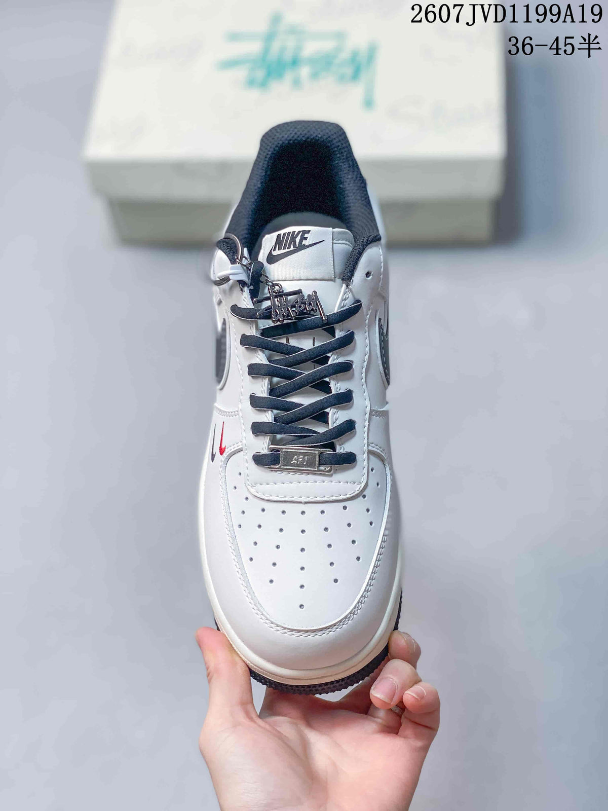 Top view of the sneaker showing the perforated toe box, dark laces, tongue branding, and decorative lace hardware.