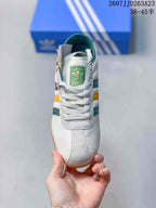 Top view showing white laces, suede-like toe detailing and the green adidas tongue label.