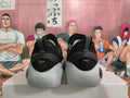 Rear view of black and gray basketball shoes with light-gray soles.