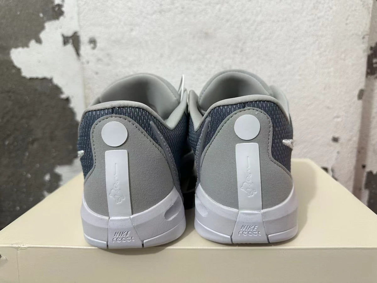 Rear view of grey Nike basketball shoes with dark mesh panels and white midsoles.