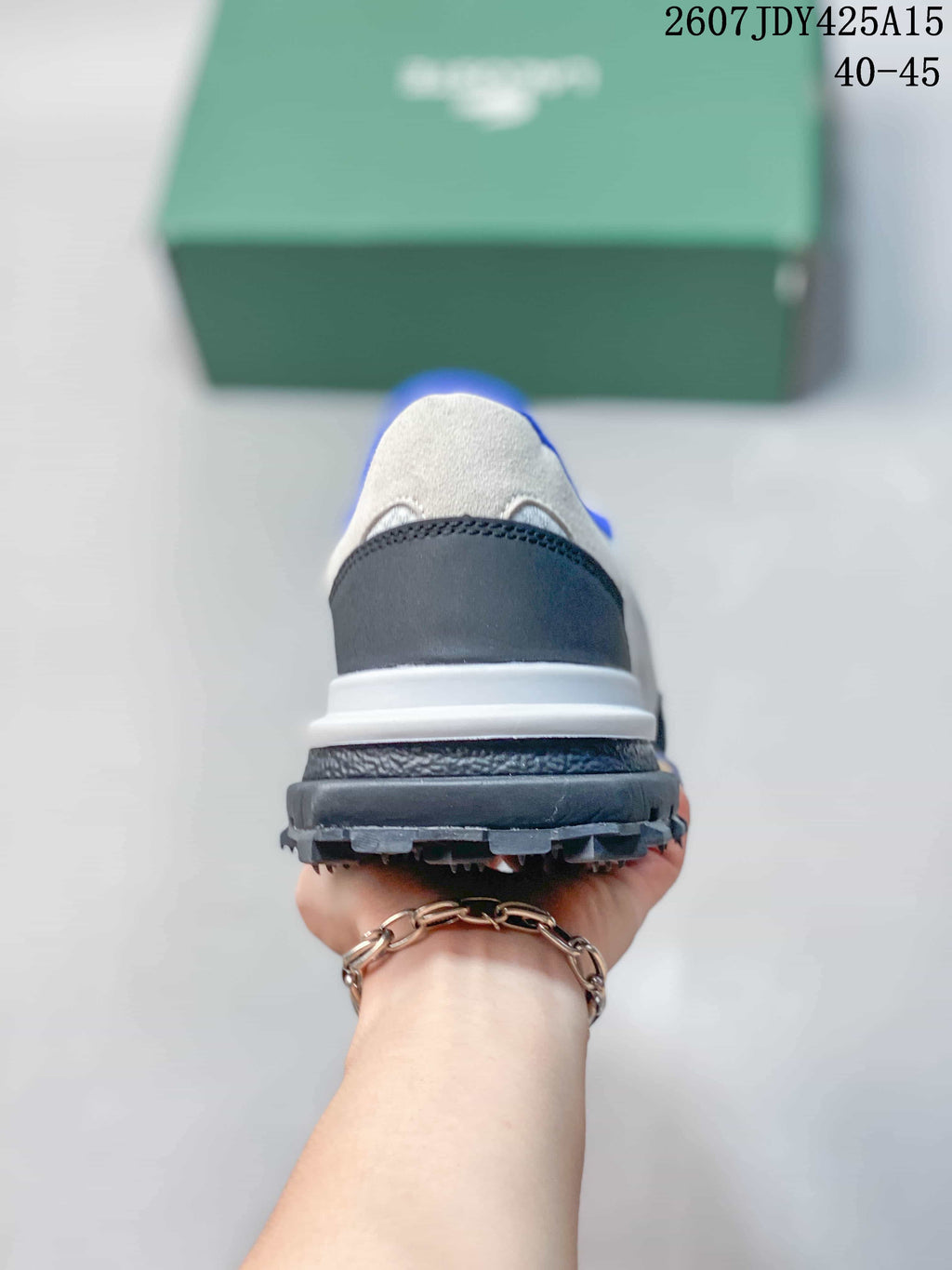 Rear view of the sneaker showing the black heel panel, white midsole, and raised dark outsole.