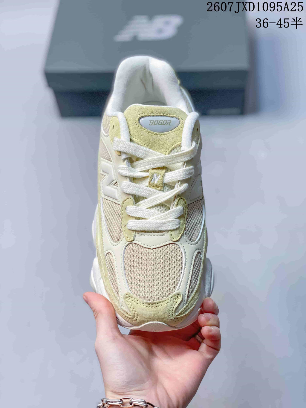 Top view of a New Balance 9060R sneaker showing the mesh toe, suede overlays, laces and tongue label.