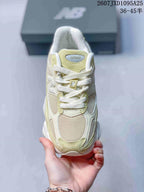 Top view of a New Balance 9060R sneaker showing the mesh toe, suede overlays, laces and tongue label.