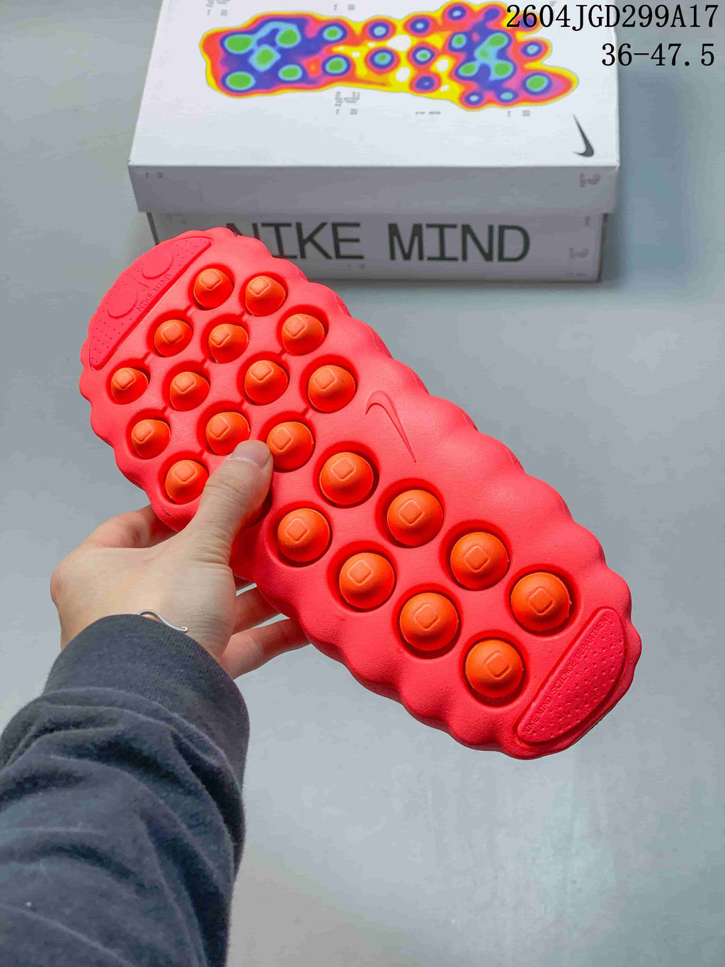 Close view of the red slide outsole showing multiple rounded traction pods.