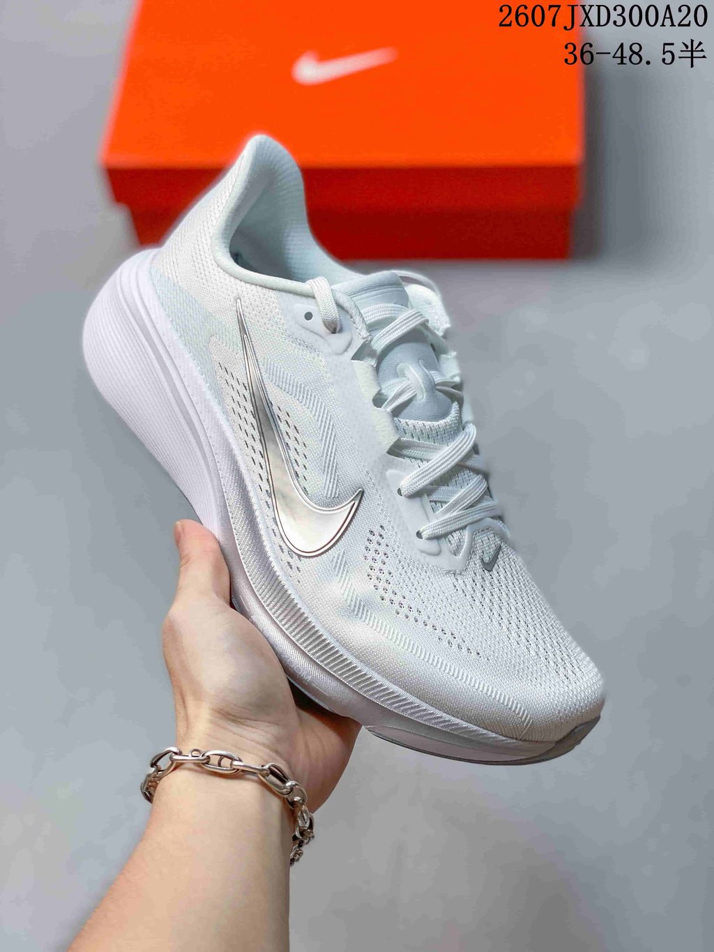 Angled side view of the white Nike Air Zoom Pegasus 42 sneaker showing the Swoosh, lace-up upper, heel shape, and white-gray sole.