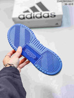 Blue patterned rubber outsole of the adidas Entrap sneaker with an adidas shoebox in the background.