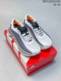 Pair of white and gray Adidas Hyperboost Edge M running shoes on a red box
