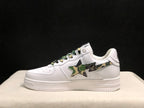 Side view of a white BAPE STA sneaker showing the camouflage star panel and embossed heel detail.