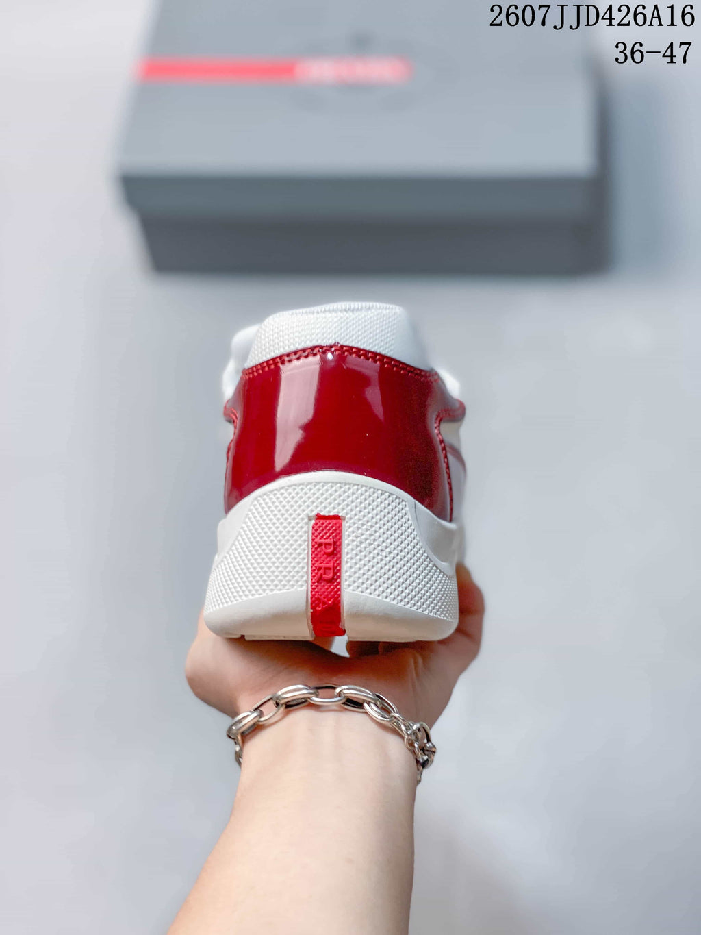 Rear view of the red and white sneaker showing the padded collar, white sole, and red heel pull detail.