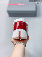 Rear view of the red and white sneaker showing the padded collar, white sole, and red heel pull detail.