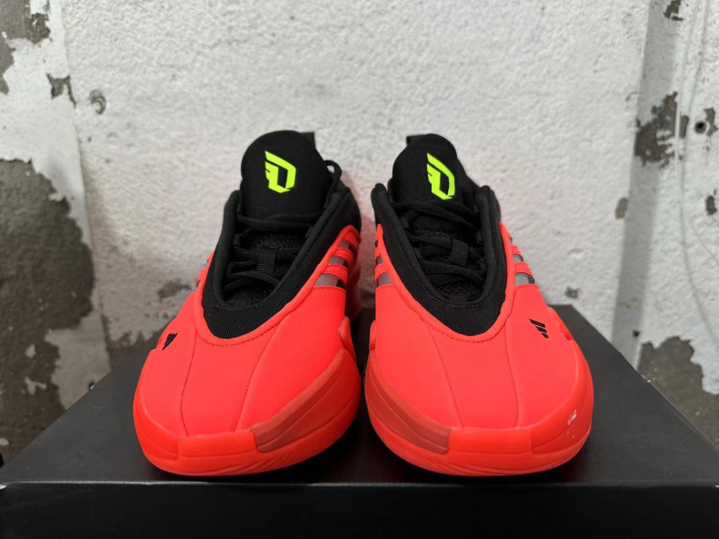 Front view of red-and-black Dame 9 basketball shoes with Dame tongue logos