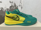 Side view of a green and yellow Nike Kobe basketball shoe with a black Swoosh.