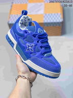 Angled close-up of a blue Louis Vuitton Trainer sneaker showing the lace system, side branding, mesh panels, and textured toe.