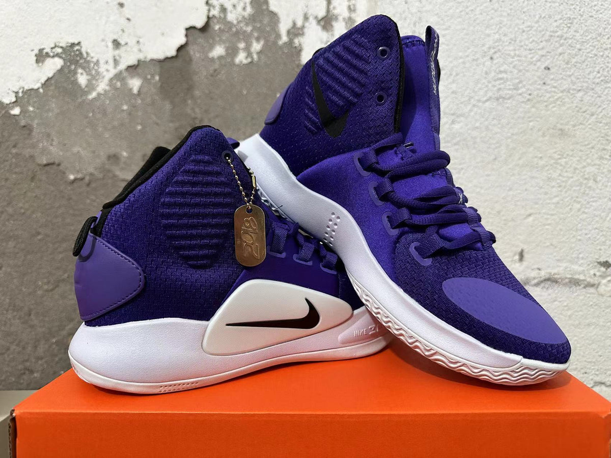Pair of purple high-top basketball shoes showing their side profile and textured outsoles