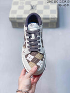 Top view showing the brown plaid toe box, white overlays, dark laces, and tongue branding.