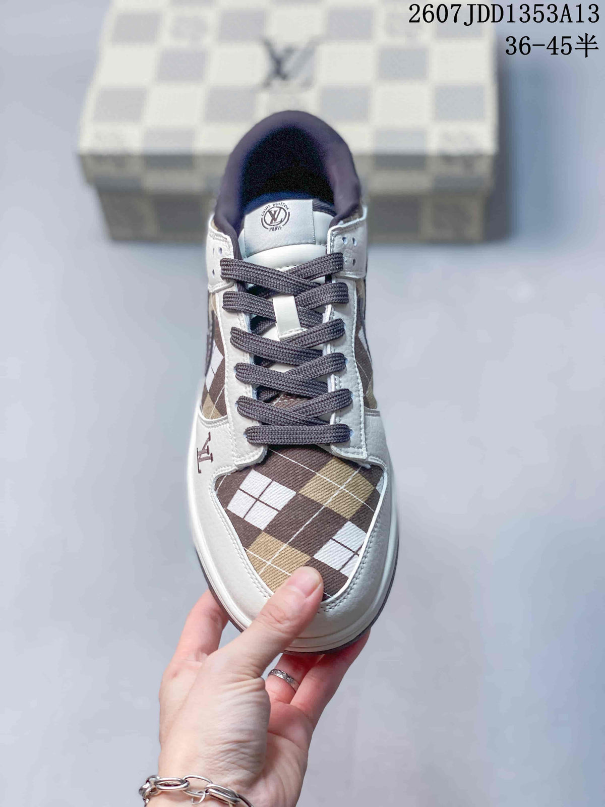 Top view showing the brown plaid toe box, white overlays, dark laces, and tongue branding.