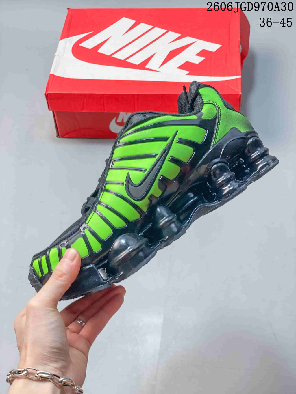 Side view highlighting the vivid green panels and column-shaped sole details