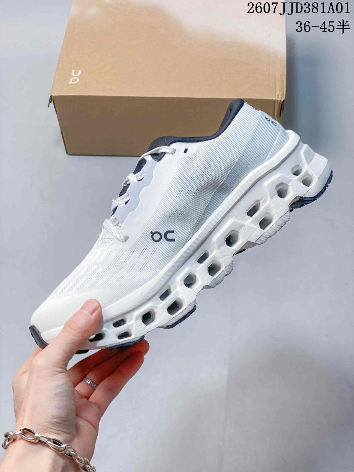 Side view of the white running shoe with a sculpted sole and navy accents