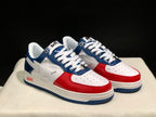 Three-quarter front view of the pair with white laces, red toe overlays, and blue panels.