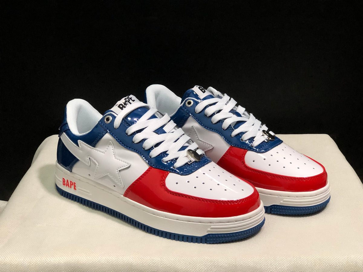 Three-quarter front view of the pair with white laces, red toe overlays, and blue panels.