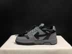 Side profile of one grey and black sneaker showing the layered upper and dark outsole.