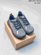 Pair of gray Norda hiking sneakers displayed on a branded shoebox, with the product code and advertised size range overlaid above.