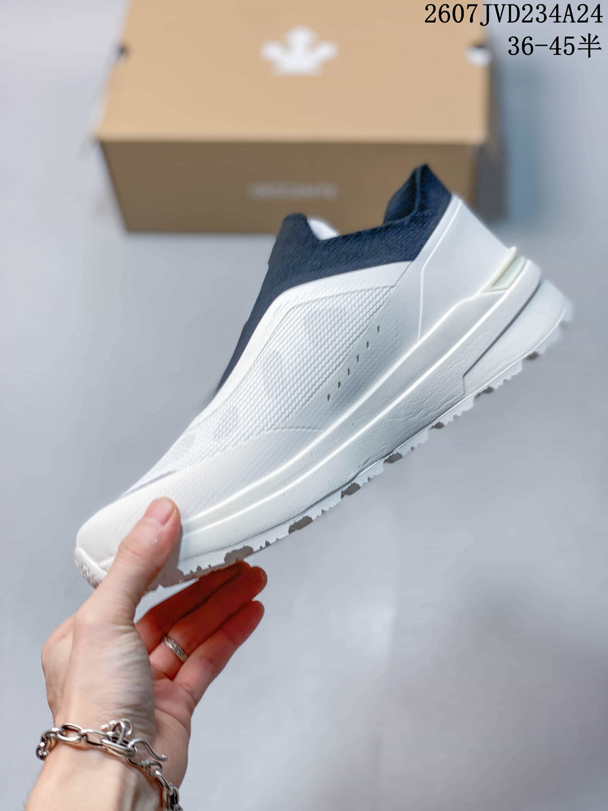 Side view showing the textured white panel, streamlined midsole and outsole tread.