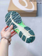 Close view of the patterned outsole, showing segmented dark green traction sections and a light-colored midsole.