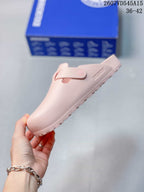 Side view of the pink closed-toe sandal with its buckle strap and textured outsole.