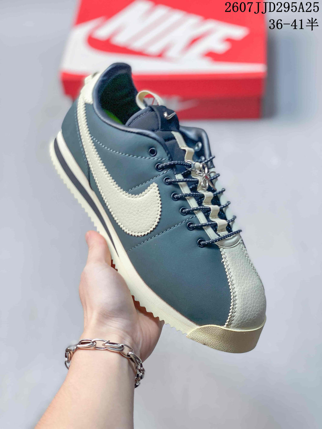 Angled side view of the navy and cream Nike sneaker showing the lace-up construction, contrast Swoosh, and textured outsole edge.