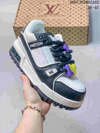 Close-up of a white and navy low-top sneaker with chunky dark laces and colorful accents