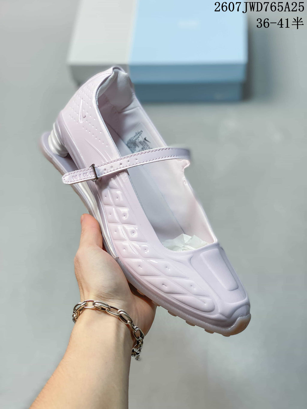 Angled side view showing the front strap, embossed side details and heel structure.