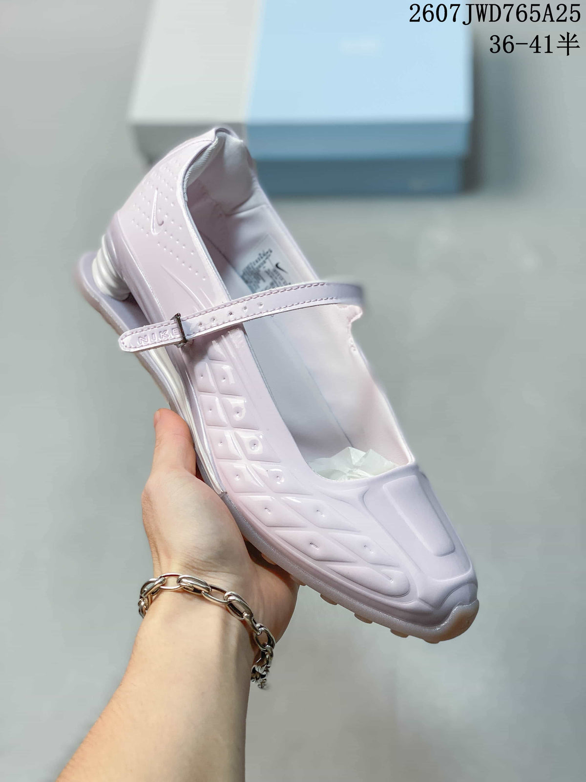Angled side view showing the front strap, embossed side details and heel structure.