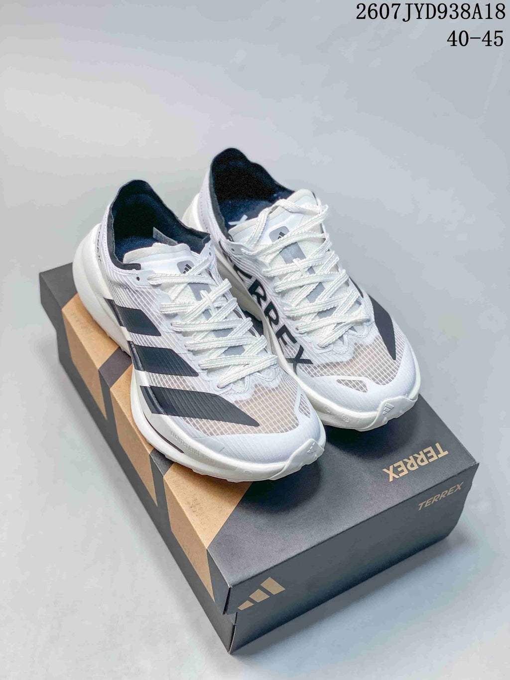 Pair of white and black Adidas Adizero Evo SL 2 running shoes displayed on a TERREX shoe box; image text shows style code 2607TYD938A18 and size range 40–45.