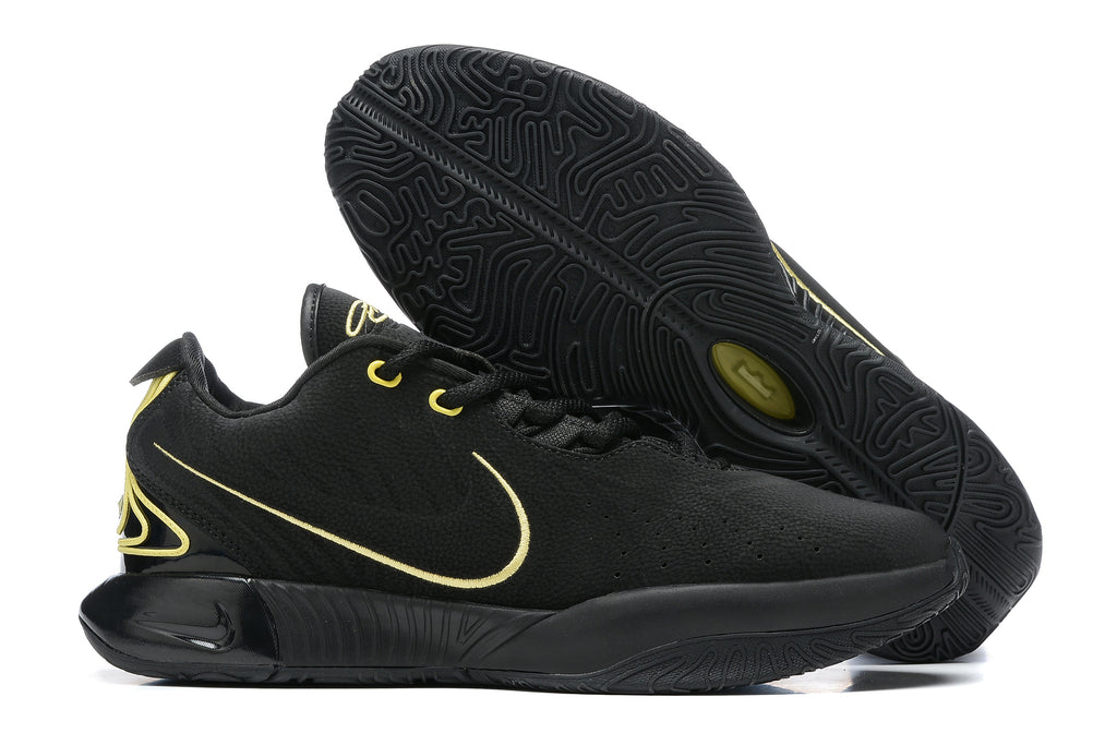 Black Nike basketball shoes with gold detailing and black outsoles.