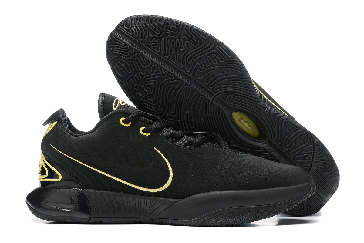 Black Nike basketball shoes with gold detailing and black outsoles.
