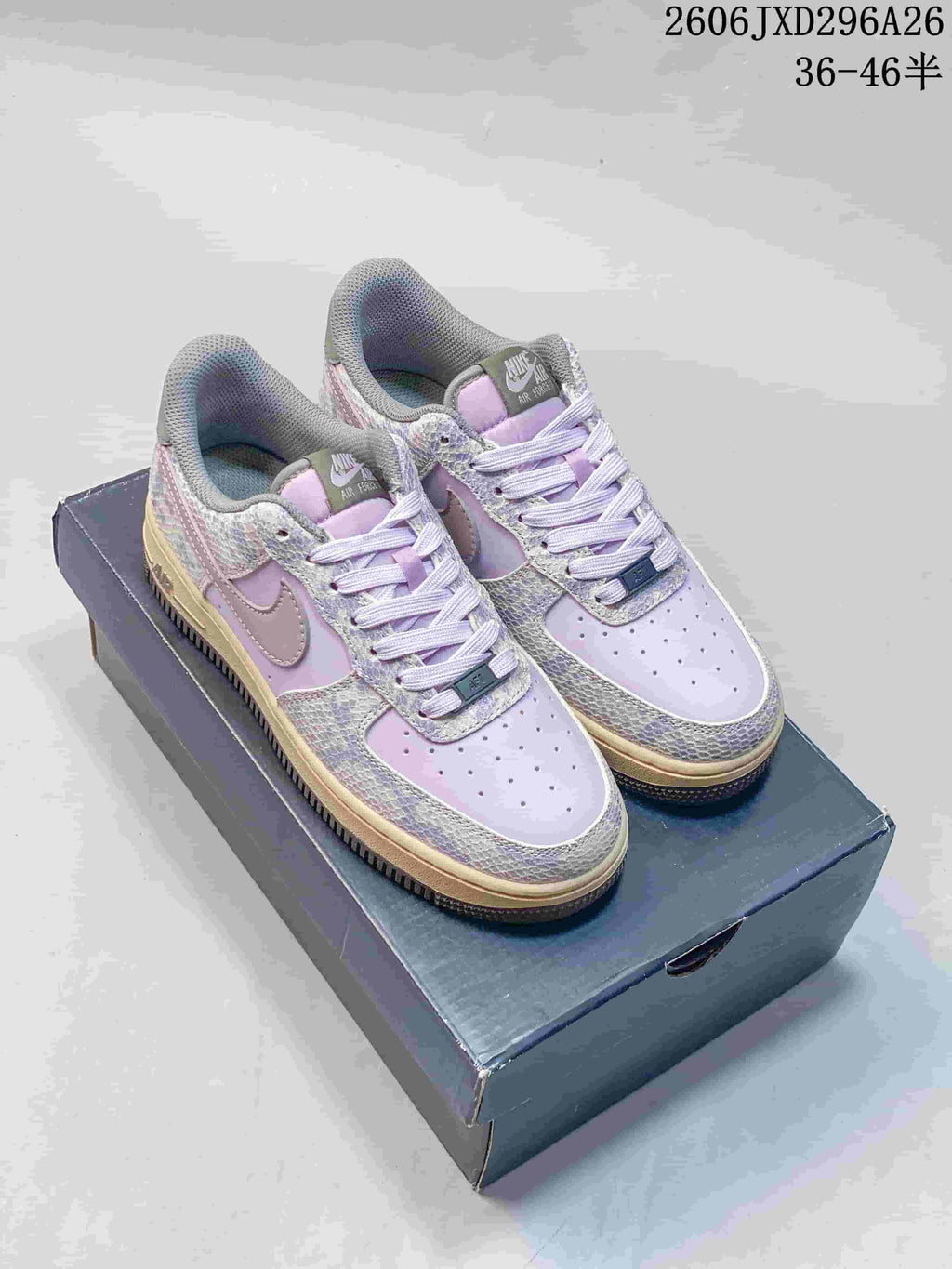 Lavender Nike Air Force 1 sneakers with patterned overlays and contrasting Swooshes.