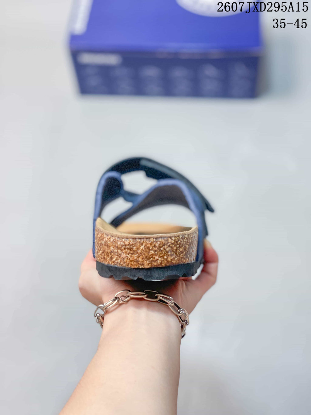 Rear view showing the open heel, cork-look midsole edge, and dark textured outsole.