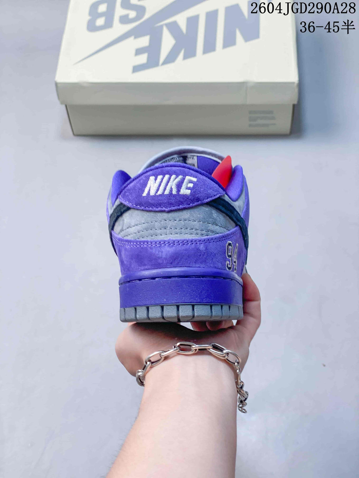 Rear view showing purple heel panels and Nike embroidery