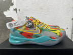 Side view of a multicolor Nike basketball shoe with yellow swoosh and turquoise heel