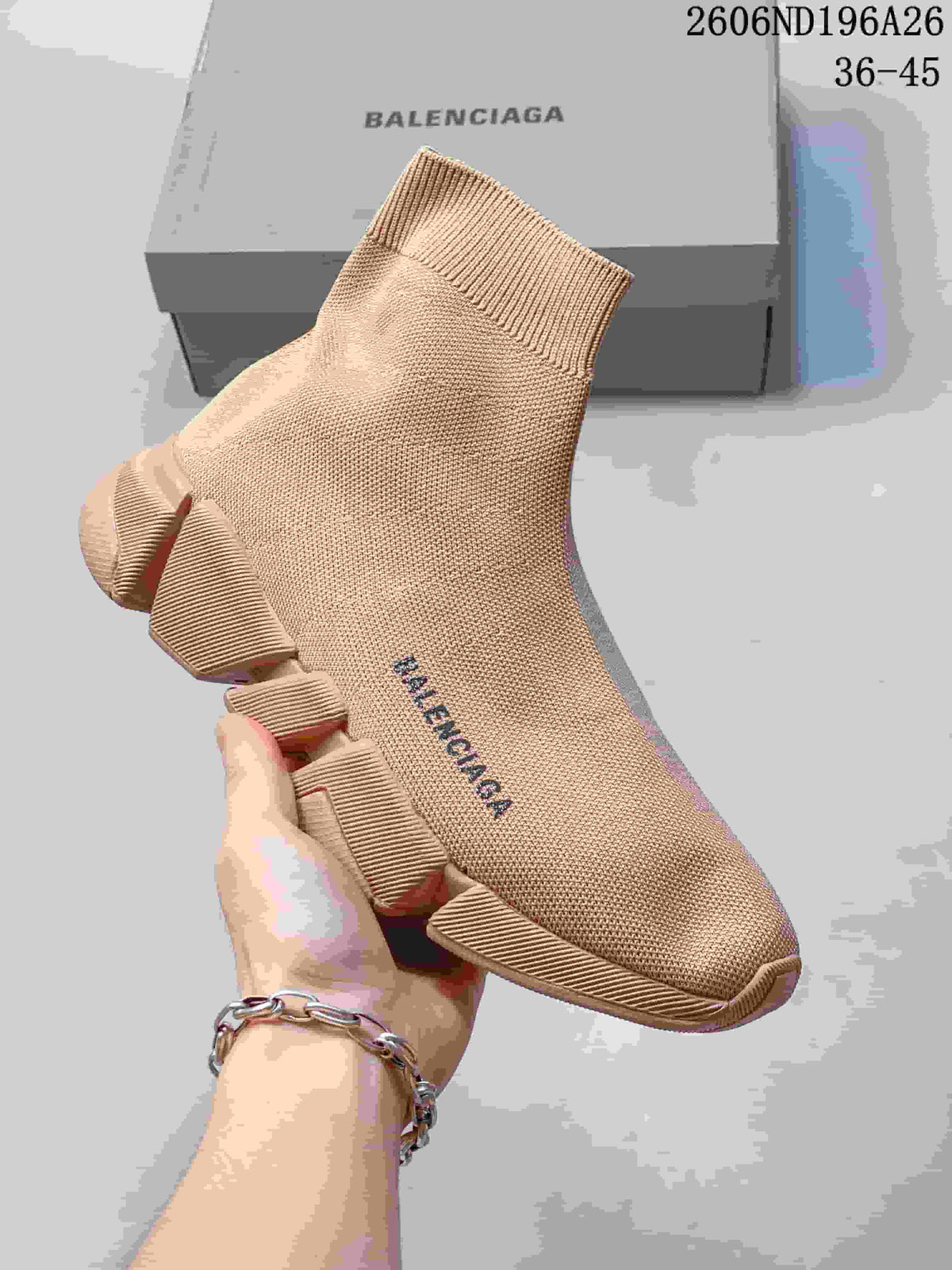 Angled front-side view of a beige Balenciaga knit sock sneaker with visible upper branding and segmented outsole.