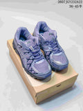 Pair of purple and gray ASICS Gel-Kayano 20 shoes displayed on a shoebox.