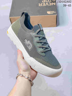 Close-up of a gray and olive The North Face Dune sneaker showing its knit-look upper and sole.