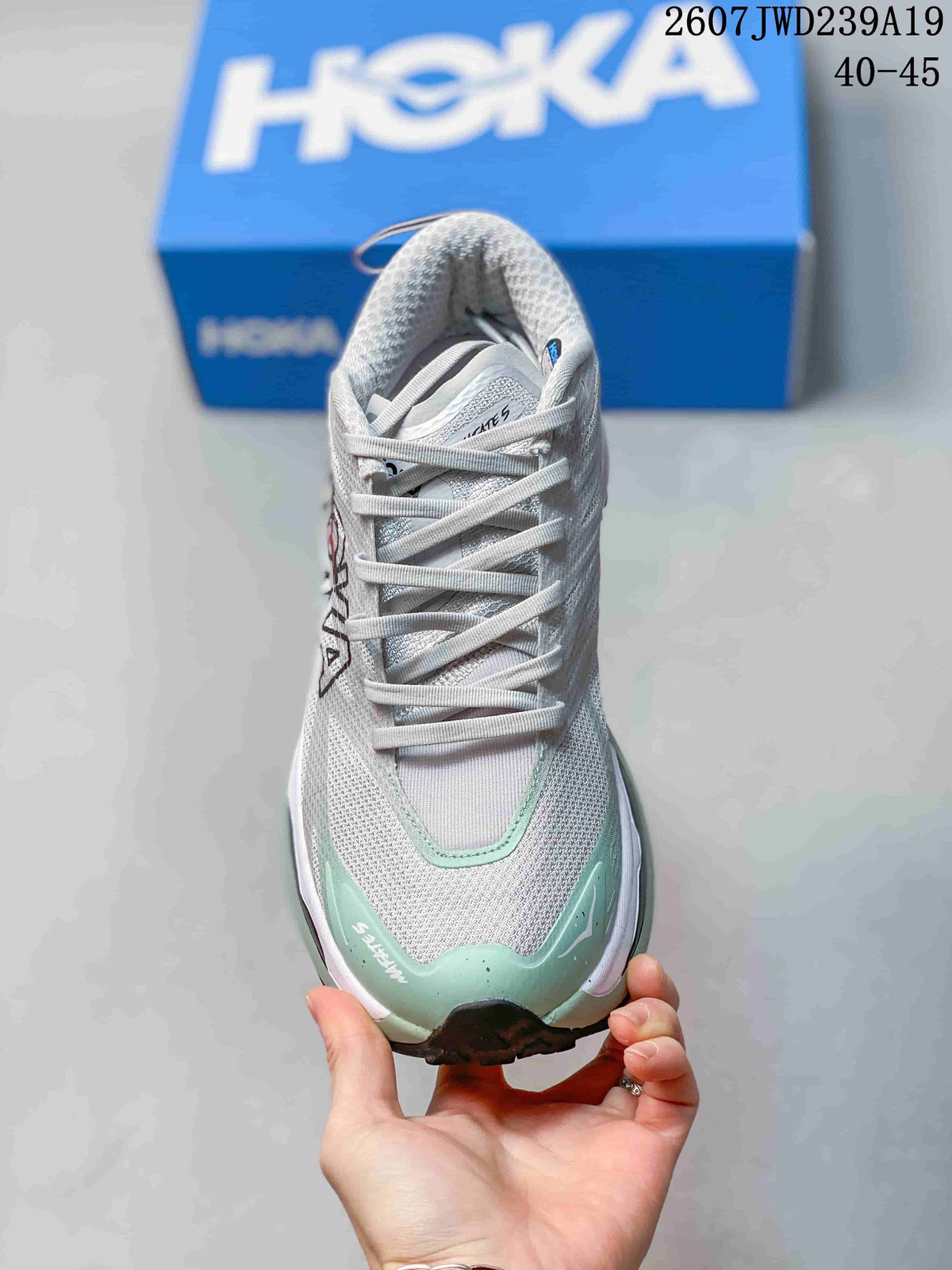 Top view of the lace-up running shoe showing the gray mesh upper and mint toe accents.