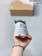 Rear view of the white sneaker showing the heel logo and sculpted outsole.