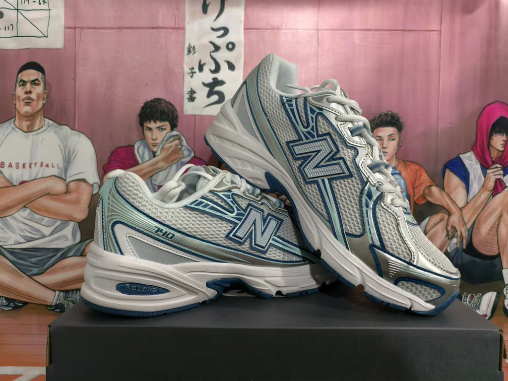 Angled side view of white and blue New Balance sneakers