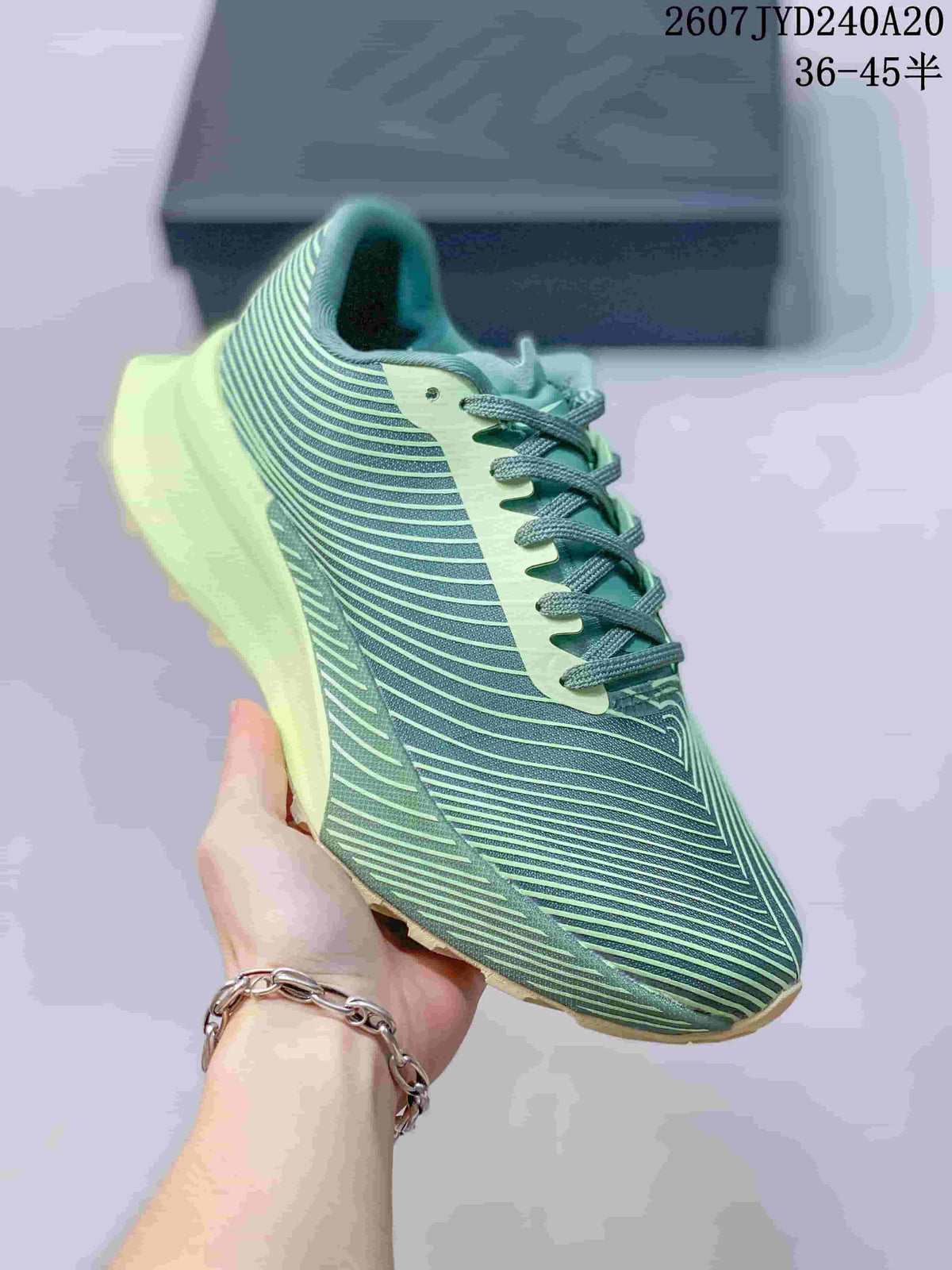 Angled side view of the green and pale lime sneaker showing the patterned upper, lace-up closure, and raised midsole.