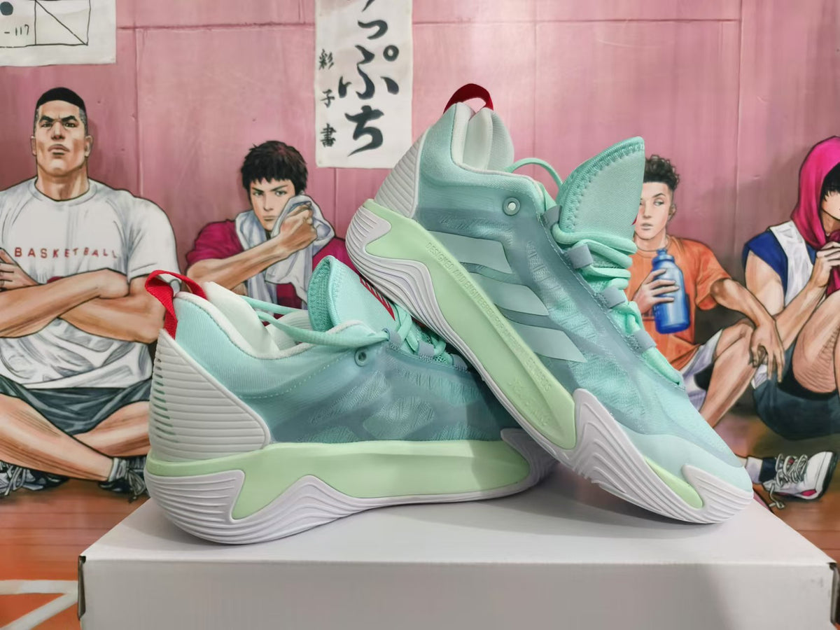 Pair of mint-green basketball sneakers shown from the side, with red accents and sculpted soles.